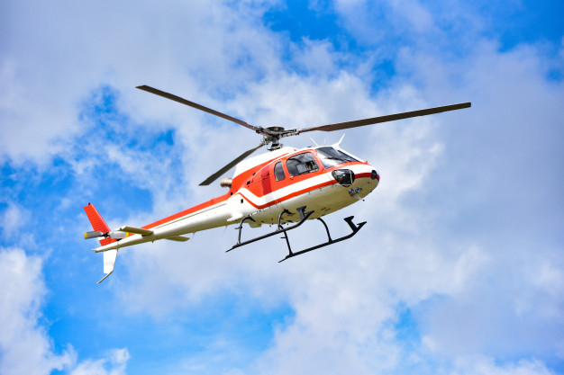 helicopter-rescue-helicopter-flying-sky-white-red-fly-helicopter-blue-sky-with-clouds-good-air-bright-day_73523-110